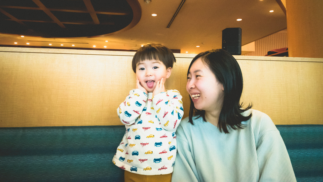 Smiling child and mother at restaurantJapanese